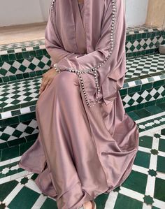 A stunning and luxurious abaya featuring pearl and diamanté detailing along the sleeves. Comes with: Outer abaya, Inner Dress, Hijab, Belt Colour may vary due to device settings. Check size guide before placing order. Dry clean only. Modest Wedding Niqab For Eid, Modest Style Khimar For Wedding And Eid, Elegant Long Sleeve Wedding Niqab, Long Khimar For Wedding Eid Festival, Long Khimar For Wedding And Eid, Elegant Maxi Length Niqab For Eid, Long Khimar For Wedding, Elegant Long Niqab For Eid, Elegant Dabka Thobe For Eid