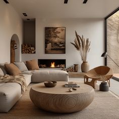 a living room filled with furniture and a fire place next to a large glass window