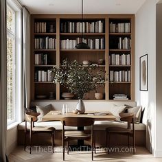 a dining room with bookshelves filled with lots of bookcases next to a window