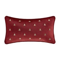 a red pillow with gold trees on it