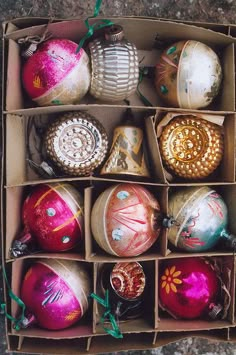 a box filled with lots of different colored ornaments