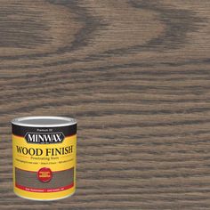 a can of minwax wood finish on a wooden surface with the paint in it