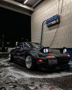 a black sports car parked in front of a building