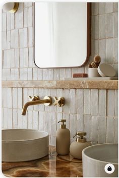 a bathroom sink with two faucets under a mirror