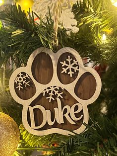 a wooden ornament hanging from a christmas tree