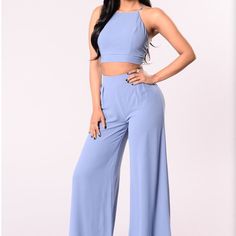 Beautiful Two Piece Set Size X Small New With Tags Crop Halter Top With Lace Up Detail. Wide Leg Pants Perfect For Any Occasion Casual Blue Two-piece Bottoms, Chic Two-piece High Waist Bottoms, Chic High Waist Two-piece Bottoms, Chic Light Blue Pants For Day Out, Chic High Waist Light Blue Wide Leg Pants, Chic Blue Bottoms For Date Night, Blue Stretch Cropped Bottoms, Chic Two-piece Solid Pants, Wide Leg Blue Jumpsuit For Day Out