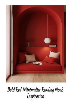 Minimalist red reading nook with cushions, pendant light, and book.