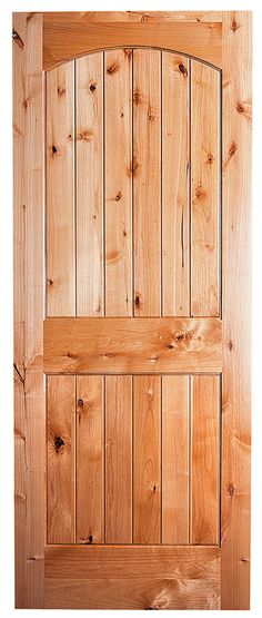 a dog is sitting in front of a wooden door that has been made out of wood planks