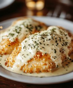 some kind of food on a plate with sauce and parmesan sprinkles