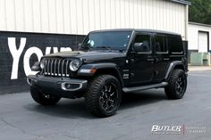 a black jeep parked in front of a building