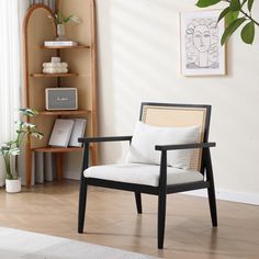 a living room with a chair, bookshelf and plants on the wall behind it