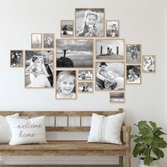 a wooden bench sitting in front of a wall with pictures on it and a potted plant