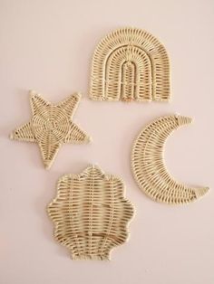 three wicker wall hangings with star, moon and crescent designs on the side