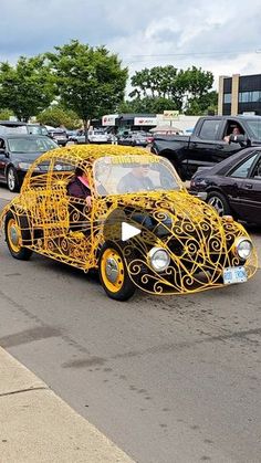 a car that is made out of wire sitting in the middle of a parking lot