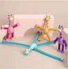 three toy giraffes sitting on top of a bath tub next to each other