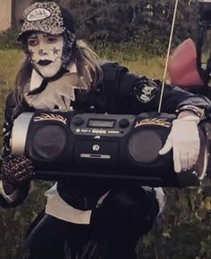 a person in costume holding a boom box