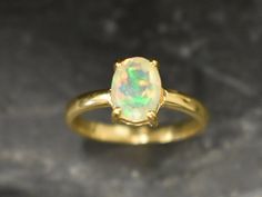 Gold Opal Ring set with a Natural Ethiopian Opal at the highest grade, diamond cut & stunning bright flashes of fire colour, at 8x6, 2 Carat. Gold Solitaire Ring made of Solid 925 Sterling Silver ☞ made to last **The ring is plated with 18k Gold (the thickest plating - 3 Micron) over Solid 925 Sterling Silver. Matching Earrings & Matching Pendant - please ask me October Birthstone - Genuine & Natural Stones ❀ ☞ Choose your size ☞ I resize (before shipping) for FREE to Any size* ⌛Last Ring left ⌛ Gold Opal Ring, Ethiopian Opal Ring, Gold Solitaire Ring, Opal Ring Gold, Fire Opal Ring, October Birthstone, Gold Plated Rings, 925 Silver Jewelry, Opal Ring