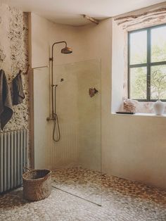 a bath room with a shower and a window