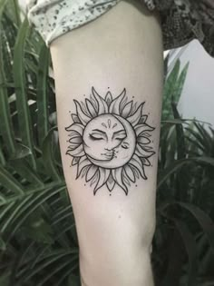 a small sun and moon tattoo on the arm