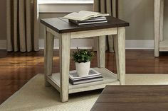 a small end table with a book on top and a potted plant in the corner