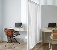 a room with a desk, chair and laptop on it