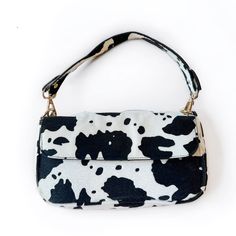 Introducing our Cowprint Purses – a bold and stylish accessory that adds a touch of playful elegance to your ensemble. These chic purses feature a classic black and white cowprint pattern that's both eye-catching and versatile. Crafted with attention to detail, these purses are designed to complement various outfits and occasions. - 10 x 6 in - Includes gold chain purse strap Chic Purses, Chain Purse, Purse Strap, Cow Print, Stylish Accessories, Black And Tan, Classic Black, Gold Chain, Gold Chains