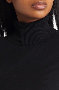 Elbow-length sleeves make this lightweight turtleneck sweater perfect for those in-between weather days. Turtleneck Elbow-length sleeves 65% rayon, 35% nylon Dry clean Imported Winter Layering Turtleneck With Ribbed Neckline, Winter Turtleneck With Ribbed Neckline For Layering, Winter Funnel Neck Turtleneck With Ribbed Neckline, Winter Turtleneck With Ribbed Funnel Neck, Fall Turtleneck With Ribbed Neckline, Fall Turtleneck With Ribbed Collar For Layering, Fall Ribbed Collar Turtleneck For Layering, Solid Turtleneck With Ribbed Funnel Neckline, Black Ribbed Turtleneck For Workwear