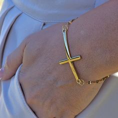 Express faith and elegance with our Stainless Steel Gold Filled Cross Bracelet. This 18K gold filled piece features a cross charm, embodying a dainty and meaningful symbol for Christians. It's a perfect religious gift for her, combining devotion with delicate style. ✨Product Features ✨ * Stainless Steel - 18k Gold Filled  💎 Size 💎 6.5 inc+1 Extender * Antitarnish * Hypoallergenic * Handmade in USA 💎 Material 💎 * Stainless Steel * Our products are produced by hand in our workshops. * Our jewe Elegant Cross Pendant Bracelet As A Gift, Adjustable Yellow Gold Crucifix Jewelry, Adjustable 14k Gold Cross Jewelry, Elegant Yellow Gold Rosary Bracelet With Cross, Elegant Yellow Gold Cross Rosary Bracelet, Adjustable Yellow Gold Cross Jewelry, Elegant Adjustable Cross Bracelet, Elegant Adjustable Crucifix Jewelry, Elegant Cross Rosary Bracelet As Gift