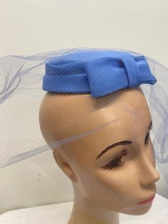 "Blue Fascinator Mid Century Hat With Bow And Veil.  Fits on top of head so it will fit anyone. Made for possibly a bridesmaid. Lightweight.  Attached comb.  1 3/4\" high 6\" across" Party Fitted Fascinator With Satin Bow, Adjustable Party Fascinator With Satin Bow, Adjustable Light Blue Fascinator For Royal Ascot, Formal Fascinator With Satin Bow, Blue Adjustable Fascinator For Wedding, Adjustable Fascinator With Matching Headband For Formal Occasions, Formal Adjustable Fascinator With Matching Headband, Adjustable Blue Fascinator For Wedding, Adjustable Satin Bow Hair Accessories For Wedding