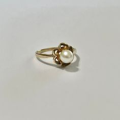 Beautiful vintage 10k yellow gold cultured pearl ring! This classic piece features a beautiful cultured pearl in a buttercup setting. Stunning retro piece of fine jewelry showcasing June's birthstone, circa 1950s! ERA - Circa 1950s, Retro MARKINGS / MATERIAL - 10k yellow gold , 1 cultured pearl MARKINGS / HISTORY - 10k gold and Siffari marking CONDITION - Good vintage condition. Very little age consistent wear. A timeless retro ring! SIZE / MEASUREMENTS - Size: 6, Rise of ring off of finger: 8 m Classic Pearl Drop Ring, Classic Gold Pearl Ring For Anniversary, Classic Yellow Gold Rings With Pearl Drop, Classic Yellow Gold Pearl Rings, Heirloom Yellow Gold Pear-shaped Ring, Heirloom Yellow Gold Pear Shaped Ring, Vintage Gold Hallmarked Pearl Ring, Classic Gold Pearl Drop Ring, Vintage Yellow Gold Pearl Ring