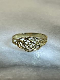 Dainty vintage 14K yellow gold ring. This lovely ring was made using milgrain and filigree style scroll designs. The ring weighs 1.17g and is a size 4.25. Band is stamped 14K with OR maker's mark for OroAmerica Jewelers. Gold was tested via Gemoro AuRacle AGT3. Yellow Gold Filigree Ring With Decorative Band For Anniversary, Anniversary Filigree Ring In Yellow Gold With Decorative Band, Anniversary Yellow Gold Filigree Ring With Decorative Band, Yellow Gold Engraved Filigree Ring, 14k Yellow Gold Filigree Ring, Yellow Gold Engraved Ring With Filigree, Yellow Gold Filigree Ring With Decorative Band As Gift, Heirloom 14k Gold Ring With Intricate Design, Heirloom 14k Gold Rings With Intricate Design