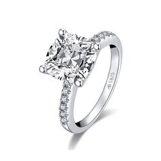 a cushion cut diamond engagement ring with side stones on the band and shoulders set in 18k white gold