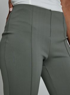 The most versatile work-to-workout pant. Crafted with a seamless scuba fabrication that feels unbelievably soft. A pull-on pant with hidden elastic waistband to contour the area. Details Model is 5'10" and wears size small/regular. Care: Machine wash cold with like colors, tumble dry low. Do not bleach, do not iron, do not dry clean. Composition: 65% Nylon | 35% Spandex Green 4-way Stretch Elastane Pants, Sleek High Stretch Solid Color Pants, Modern Stretch Bottoms In Solid Color, Green Stretch Elastane Pants, Modern Stretch Solid Bottoms, Modern Stretch Bottoms, Green Elastane Pants With 4-way Stretch, Modern Stretch Bottoms With Elastic Waistband, Spring Stretch Pants With Seam Detailing