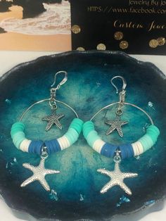 These darling sea star hoop earrings are made with turquoise, white and blue, 6 mm clay spacer disc beads, silver sea star dangles & sterling silver French earring hooks.  They are so stunningly gorgeous, and they are the perfect beach accessories. Blue Hoop Earrings With Ear Wire For Beach, Turquoise Bohemian Hoop Earrings For Beach, Bohemian Turquoise Hoop Earrings For Beach, Nickel-free Starfish Earrings Ocean-inspired, Star Charm Drop Earrings For Beach, Handmade Ocean-inspired Earrings For Beach Season, Handmade Ocean-inspired Star Earrings, Handmade Turquoise Hoop Earrings For Beach, Handmade Star-shaped Jewelry For Vacation