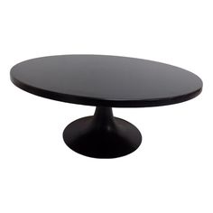 a black table with an oval top on a white background in front of a white backdrop