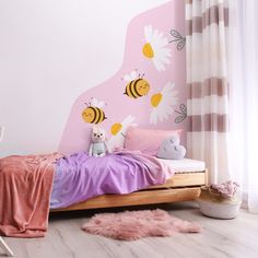 a child's bedroom with pink walls and bedding, stuffed animals and flowers on the wall