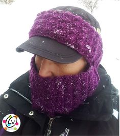 a man wearing a hat and scarf in the snow