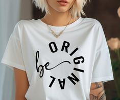 a woman with blonde hair wearing a white t - shirt that says, origg town