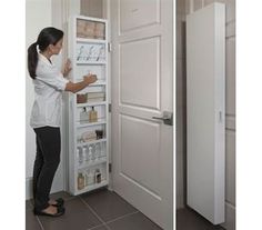 a woman is looking into an open refrigerator