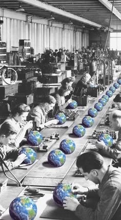 an assembly line with people working on blue and green globes in front of them