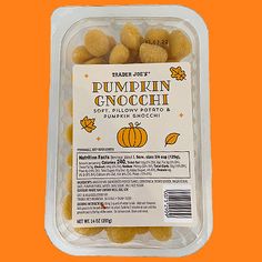 pumpkin gnocchi nuts in a plastic container on an orange background with the label