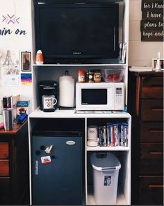 a microwave oven sitting on top of a white shelf