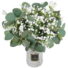 a vase filled with white flowers and green leaves