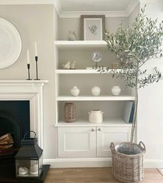 a living room filled with furniture and a fire place in front of a white fireplace