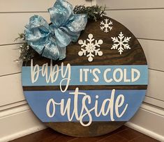 a wooden sign that says baby it's cold outside