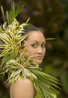 a woman is holding some plants in her hand