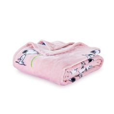 a pink blanket with black and white birds printed on the front, sitting on top of a white surface