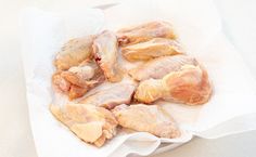 raw chicken wings on a white paper towel