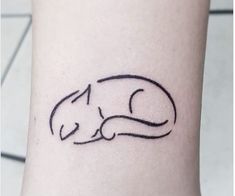 a small cat tattoo on the ankle is shown in black ink with a white background