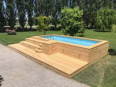 an above ground pool surrounded by grass and trees